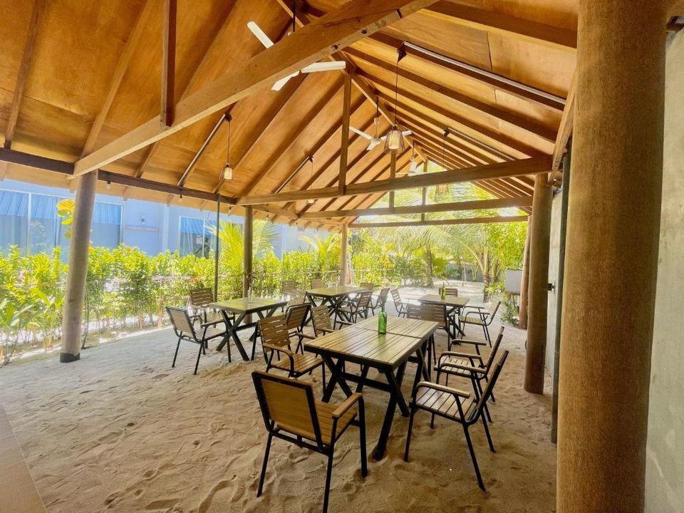 Wooden pavilion restaurant with sand floor