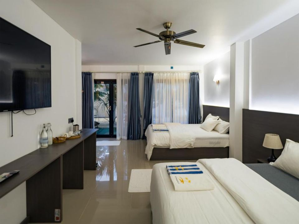 La Palma Suites family room with two beds