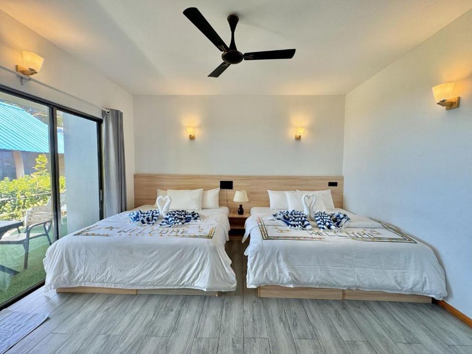 Family villa room with two double beds and garden view